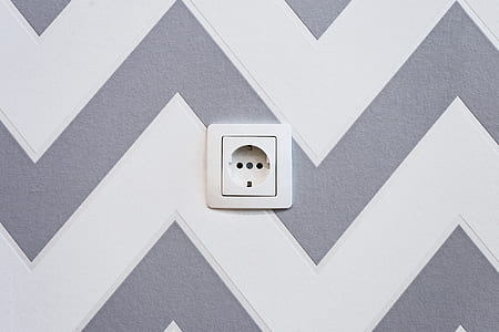 white electric socket mounted on chevron wall thumbnail