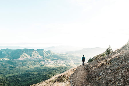 man standing beside mountain thumbnail