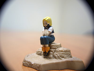 woman sitting on rock ceramic figurine thumbnail