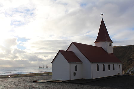white and brown house near sea at daytime thumbnail