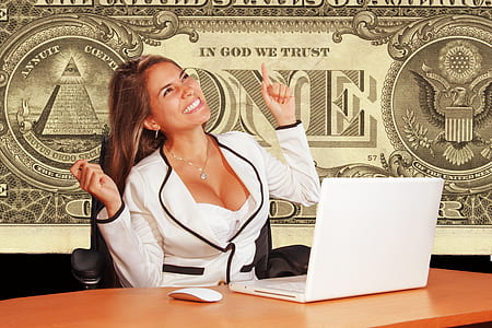 smiling woman sitting in front of white laptop computer thumbnail
