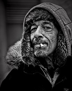 grayscale photo of man in capt thumbnail