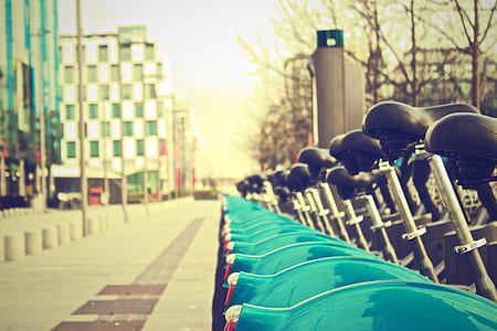 black bicycle parked beside buildings \ thumbnail