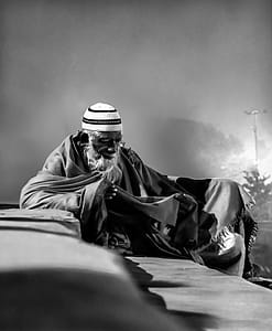 Grayscale Photo of Man With Taqiyah Cap thumbnail