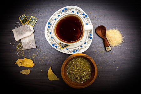 pancake with syrup on plate near two tea bags and pepper on bowl thumbnail