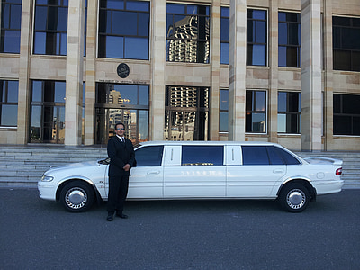 man standing beside white limousine thumbnail