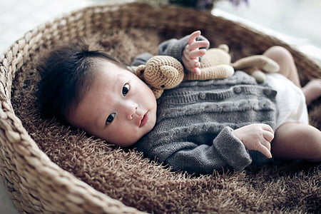 baby, children, beige, one hundred days, lying down, looking at camera thumbnail