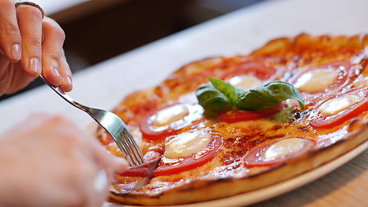 person about to slice pizza thumbnail