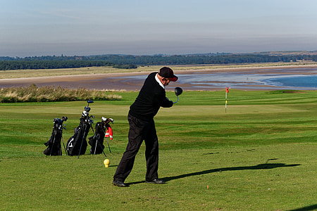 man playing golf under sunny sky thumbnail
