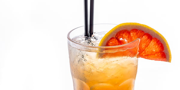 clear glass cup with slice lime juice and yellow beverage thumbnail