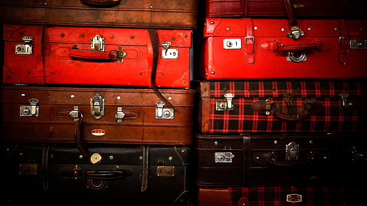 assorted-color luggages piled on top thumbnail