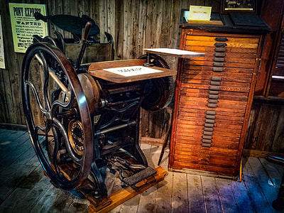 brown and black metal vintage machine near wooden plan chest thumbnail
