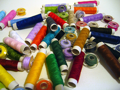 assorted-color thread lot on white surface thumbnail