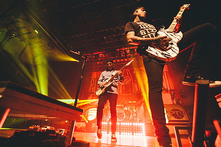 two men playing electric guitars thumbnail