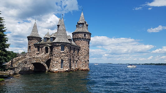 agrey castle surrounded by body of water at daytime thumbnail