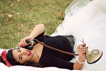 Woman In Black And White Tutu Dress Holding Cradle Phone thumbnail