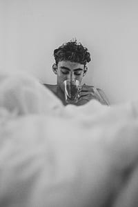 man drinking tea grayscale photo thumbnail