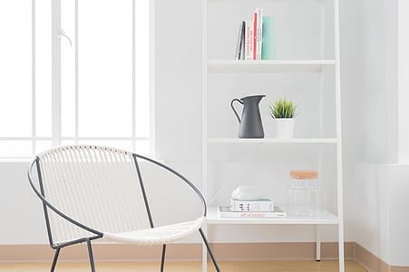 white armchair with gray steel frame near white wooden 3-layer shelf thumbnail