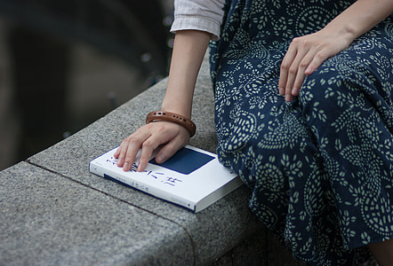person sitting on gray bench thumbnail
