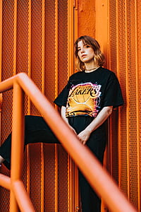 woman wearing black Los Angeles Lakers-printed shirt and black pants thumbnail