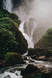 waterfalls near rock formation at daytime thumbnail