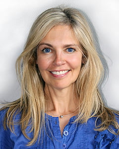 woman smiling at the camera wearing blue top thumbnail