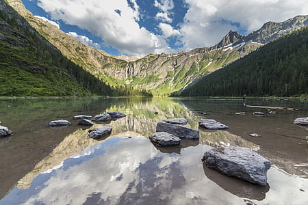 stones on calm waters near mountain thumbnail