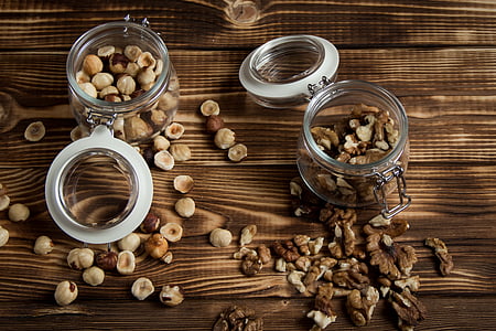two clear mason jars on brown wooden table thumbnail