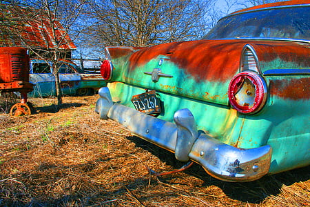 rusted teal classic car on grass field thumbnail