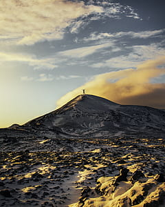 person standing at the peak of snow-covered mountain thumbnail