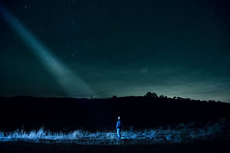 man standing on the field during nighttime with spot light thumbnail