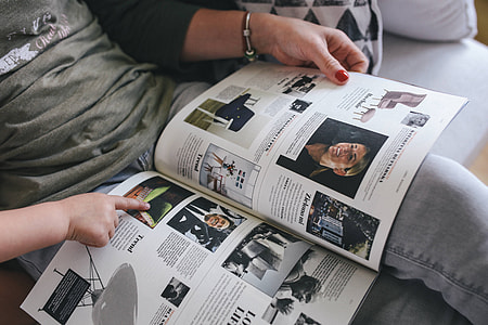 Woman reading a designer magazine on a couch thumbnail