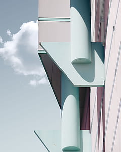 blue and grey concrete building under grey sky and white clouds thumbnail