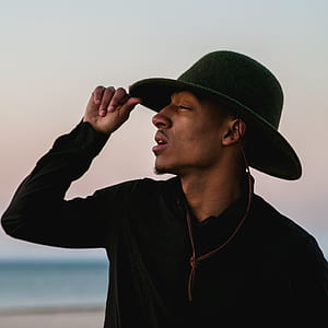 man wearing black polo shirt and hat thumbnail