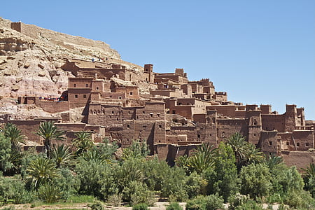 brown concrete buildings near hill during daytime thumbnail