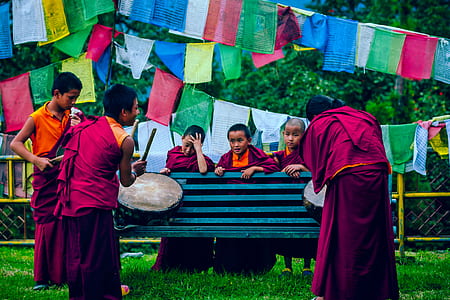 children's playing drums facing on bench thumbnail