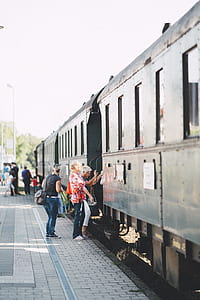 person standing in front of gray train thumbnail