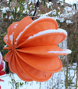 orange hanging decor covered with snow thumbnail