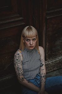 woman looking towards camera sitting in front of door thumbnail