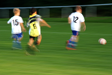 three boys playing soccer thumbnail