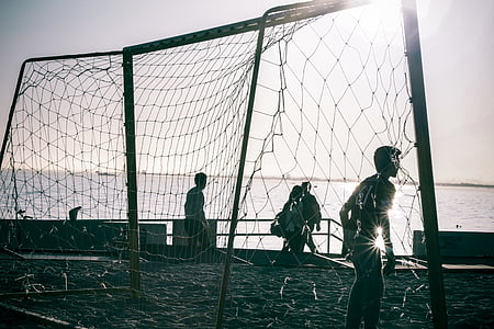 people playing soccer on seashore thumbnail