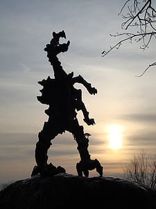 silhouette of dinosaur during golden hour thumbnail