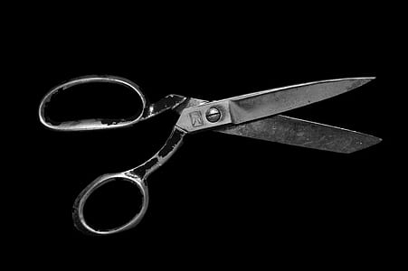 gray scissors on black background thumbnail
