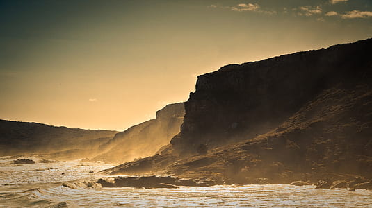 rock formation near body of water thumbnail