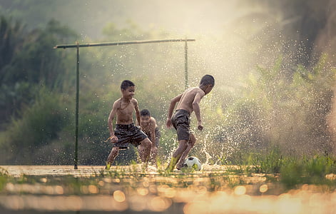 tilt-shift photography of children playing with water thumbnail