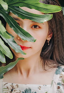 Woman Posing Behind Plant thumbnail