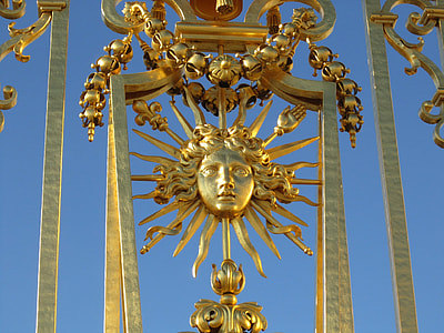 gold Medusa head decor under blue sky during daytime thumbnail