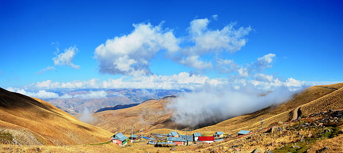 houses on mountains during daytime thumbnail