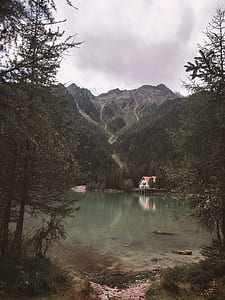 house in front lake surround mountains thumbnail