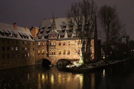 brown boat near brown buildings at night time thumbnail